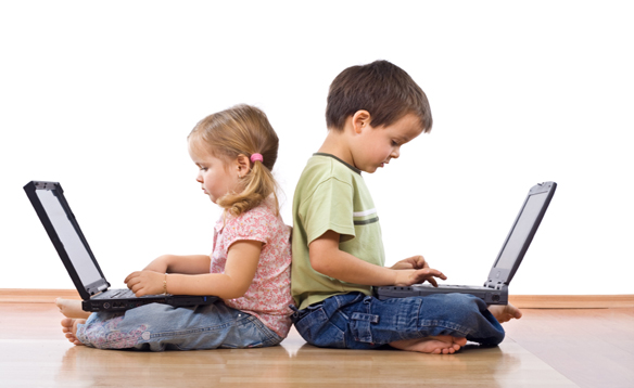 Little girl and boy using laptops